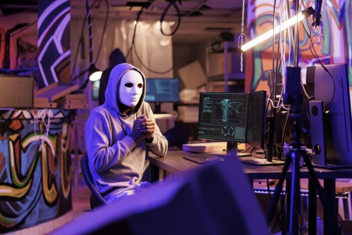 Anonymous hacker filming scam video